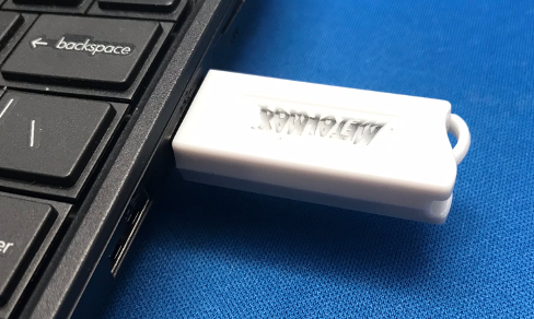 A usb stick connected to a computer
AI-generated content may be incorrect.