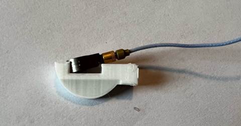 A small white object with a wire
AI-generated content may be incorrect.