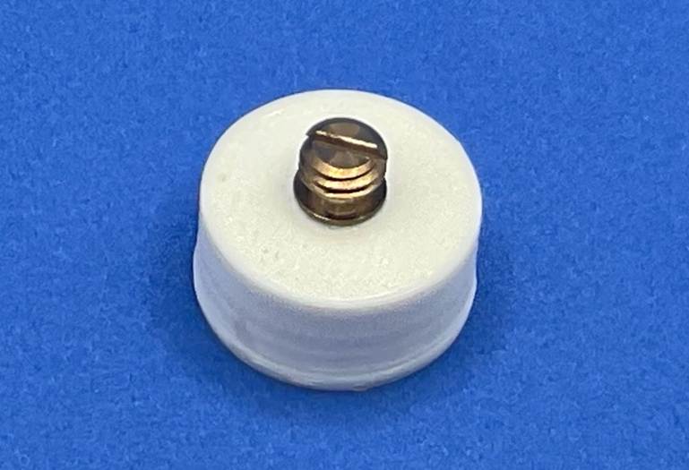 A white plastic object with a screw

AI-generated content may be incorrect.