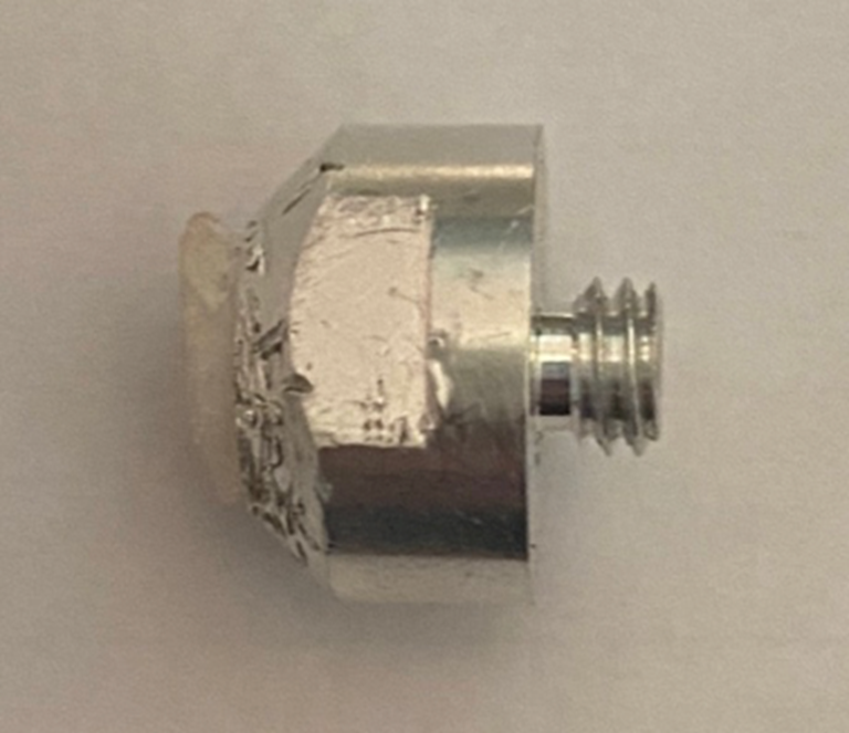 A silver object with a screw

AI-generated content may be incorrect.